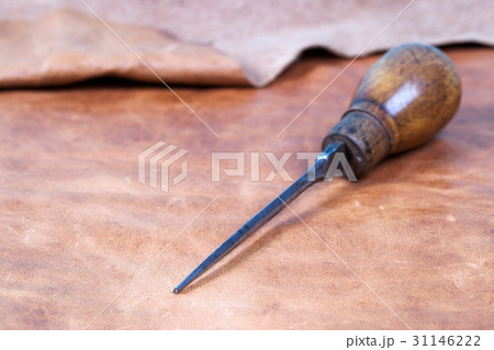 Leather craft tools on a wooden background Leather craft tools on a wooden background 31146222