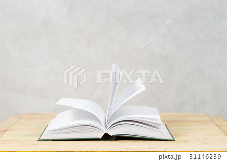 Open book on wooden table. 31146239