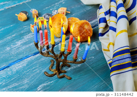 The menorah with candles and sweet donuts The menorah with candles and sweet donuts 31148442