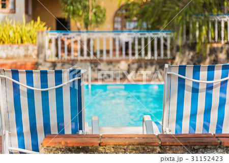 Cuba, Havana, Deck chairs by swimming pool 31152423