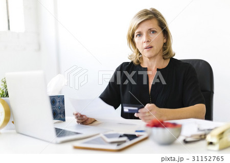 Portrait of Mature woman paying bills Portrait of Mature woman paying bills 31152765