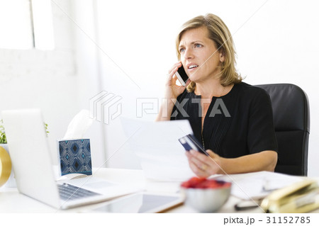 Displeased Mature woman paying bills Displeased Mature woman paying bills 31152785