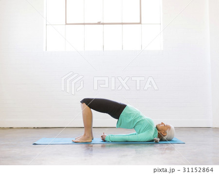 Senior woman practicing yoga on mat 31152864