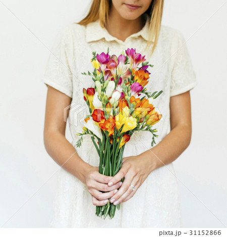 Woman holding bouquet of freesias 31152866