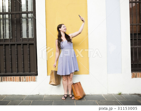 Puerto Rico, San Juan, Beautiful woman doing selfie on city street Puerto Rico, San Juan, Beautiful woman doing selfie on city street 31153005
