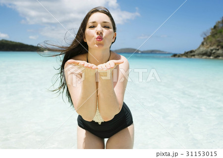 USA, Virgin Islands, Saint Thomas, Beautiful woman blowing kisses on beach USA, Virgin Islands, Saint Thomas, Beautiful woman blowing kisses on beach 31153015