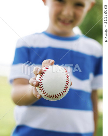 Young boy (6-7) holding baseball ball Young boy (6-7) holding baseball ball 31153038