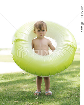 Boy (2-3) standing with inflatable ring 31153049
