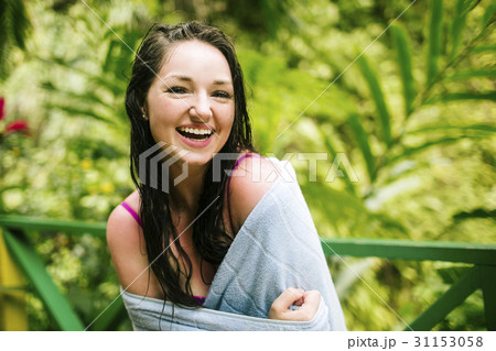 Caribbean Islands, Saint Lucia, Woman with wet hair wrapped in towel with lush foliage in background 31153058