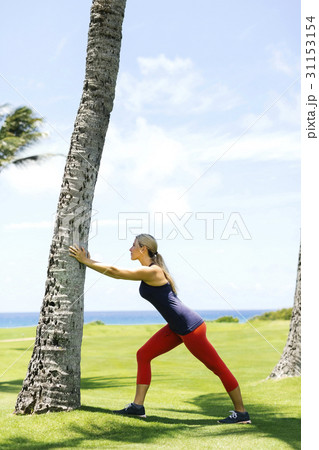 USA, Hawaii, Kauai, Woman exercising near sea USA, Hawaii, Kauai, Woman exercising near sea 31153154