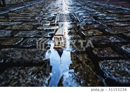 Spain, Andalusia, Seville, La Macarena, Church reflecting on wet cobblestone street Spain, Andalusia, Seville, La Macarena, Church reflecting on wet cobblestone street 31153156