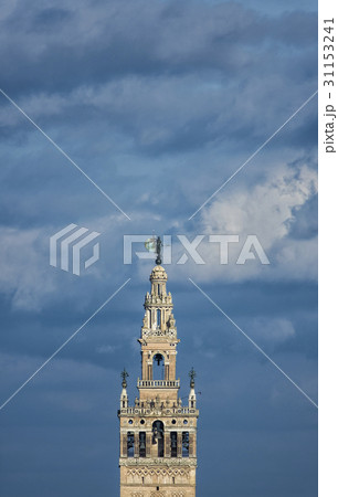 Spain, Seville, Top of Giralda Tower against clouds 31153241