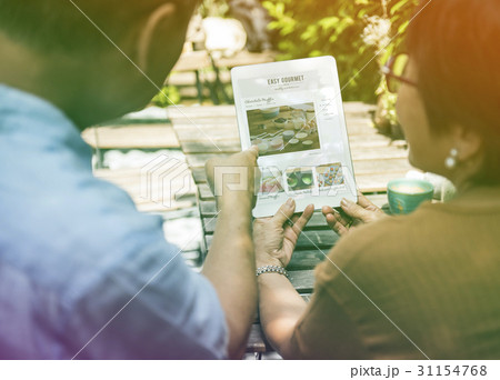 Sweet couple learning pastry on digital tablet 31154768