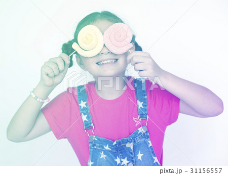 Little girl playful happiness with lollipop Little girl playful happiness with lollipop 31156557