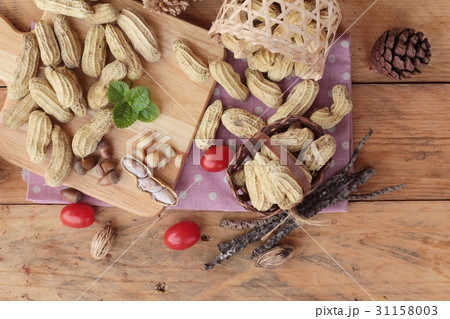 Peanut and boiled peanuts on wood background. Peanut and boiled peanuts on wood background. 31158003