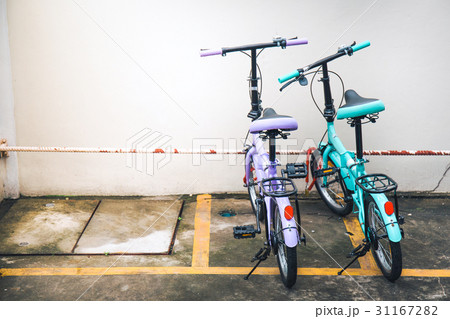 Two bicycles parked at the parking. 31167282