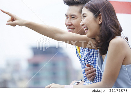 a couple is looking at the same direction. 31171373