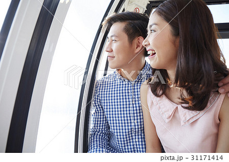 Young couple is sightseeing in a cable car. 31171414