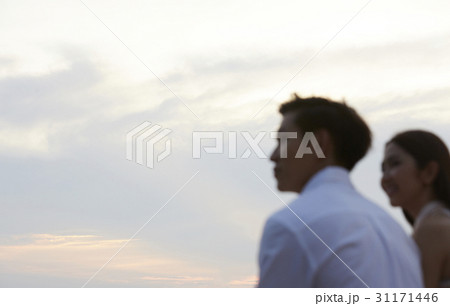 Young couple is watching the sunset together. Young couple is watching the sunset together. 31171446