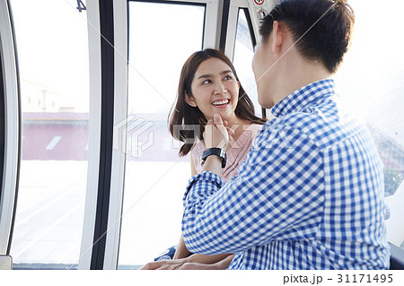 a man is touching a happy woman's chin indoors. a man is touching a happy woman's chin indoors. 31171495