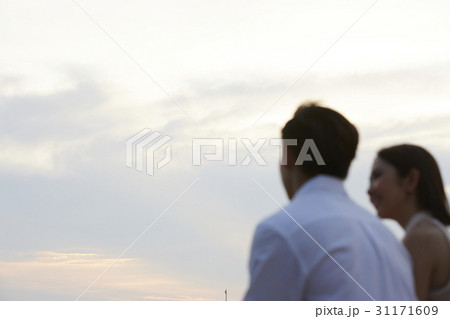 The couple is chatting and watching the sunset The couple is chatting and watching the sunset 31171609