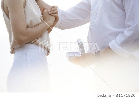 A man is giving a ring to propose his love. A man is giving a ring to propose his love. 31171920