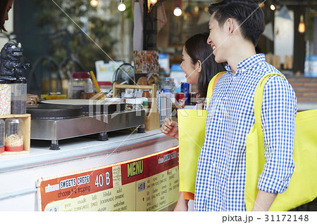 a man and woman is happily waiting to buy food 31172148