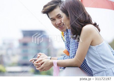 a man is talking something to a woman outdoors a man is talking something to a woman outdoors 31172197