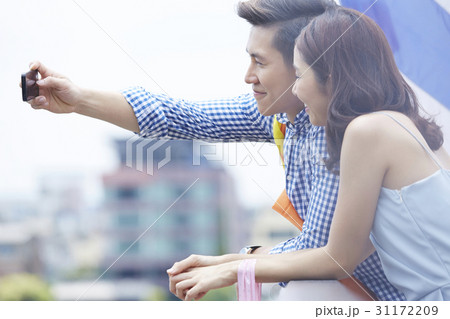 a photo of a man and woman smiling and taking selfie 31172209