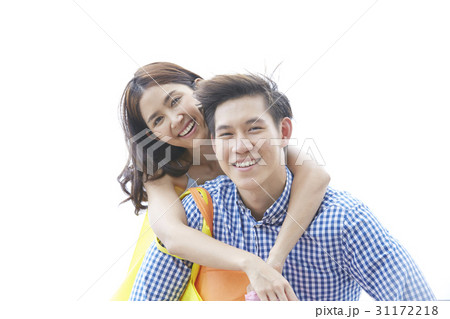 a portrait of a couple smiling with the man carrying the woman on his back 31172218