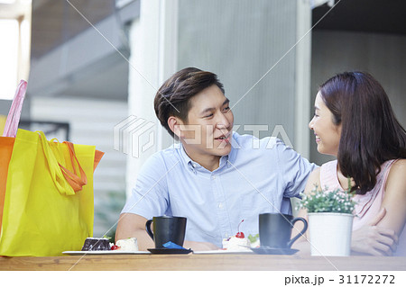a man and woman are sitting and happily taking in a coffee shop a man and woman are sitting and happily taking in a coffee shop 31172272