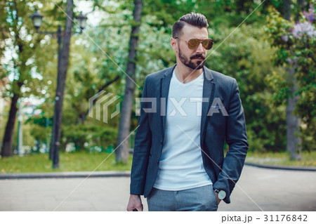Stylish man with a beard and in sunglasses Stylish man with a beard and in sunglasses 31176842
