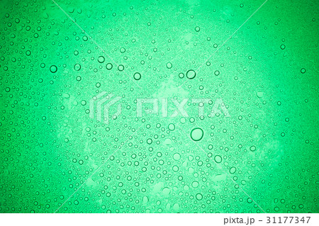 Rain droplets on green glass background. 31177347