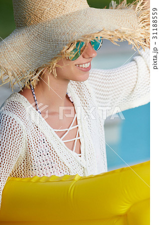 Young happy woman relaxing in a swimming pool Young happy woman relaxing in a swimming pool 31188559