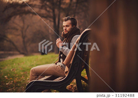 young man sitting on bench 31192488