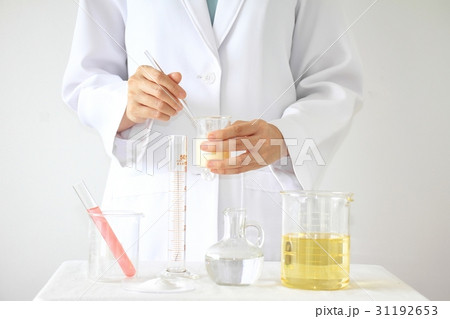 Pharmacist formulating the chemical for medicine. 31192653