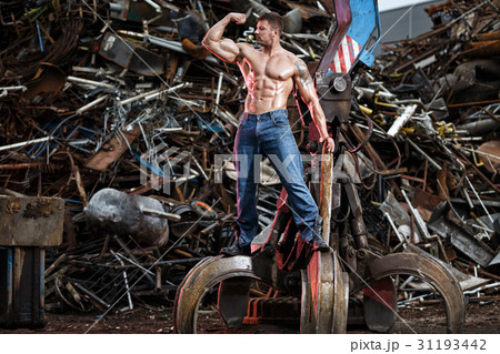 Muscular man and heavy equipment Muscular man and heavy equipment 31193442