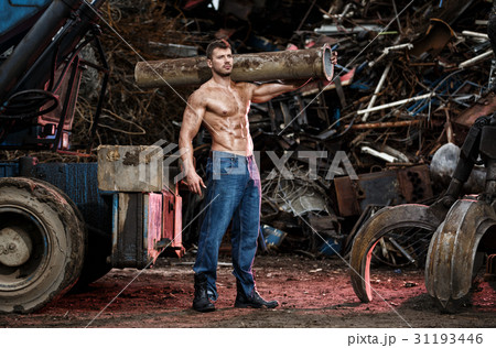 Muscular man working on junkyard 31193446