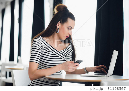 Charming Caucasian woman using mobile phone and Charming Caucasian woman using mobile phone and 31198567