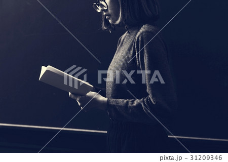 Girl with Glasses Standing Reading Book Girl with Glasses Standing Reading Book 31209346