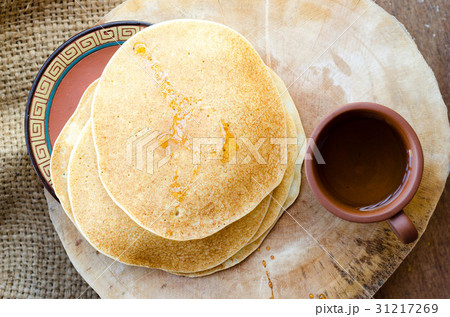Several yellow crepes with cup of tea Several yellow crepes with cup of tea 31217269