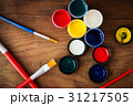 watercolors and brushes on wooden background 31217505