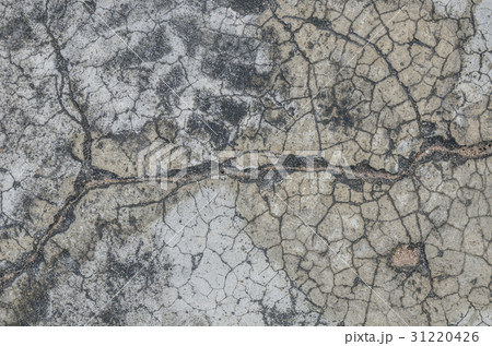 A texture of cracked paint on a concrete wall A texture of cracked paint on a concrete wall 31220426