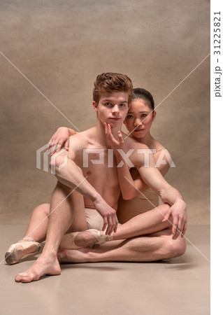 Couple of ballet dancers posing over gray Couple of ballet dancers posing over gray 31225821