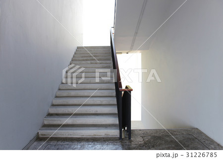 Concrete Stairs with white walls, wooden handrail 31226785