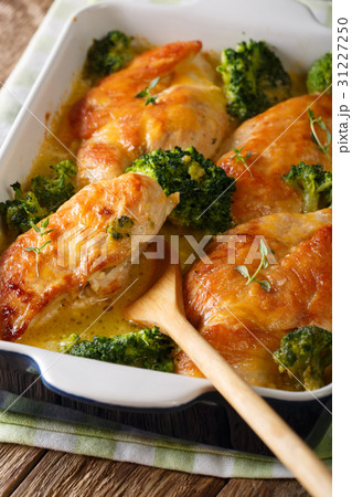 Tasty chicken fillet and broccoli baked in cheese Tasty chicken fillet and broccoli baked in cheese 31227250