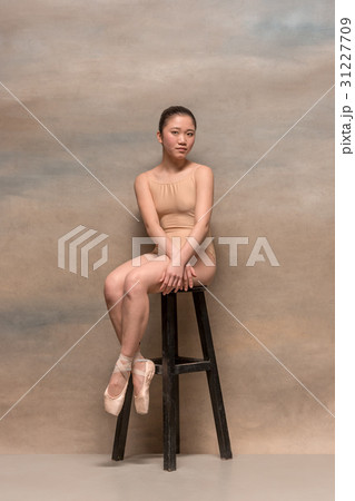 Tired ballet dancer sitting on the wooden chair on Tired ballet dancer sitting on the wooden chair on 31227709