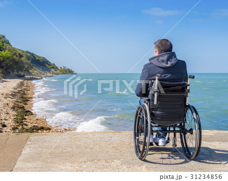 Back of disabled man in wheelchair at beach 31234856