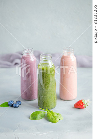 Variaty of Smoothie in bottles Grey background Variaty of Smoothie in bottles Grey background 31235205