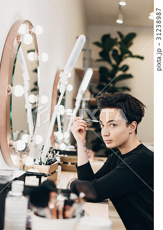 Attractive woman at the mirror in beauty studio 31238987